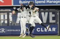 New York Yankees' Alex Verdugo, left, Aaron Judge, center, and Juan Soto celebrate after defeating the Miami Marlins in a baseball game, Tuesday, April 9, 2024, in New York. The Yankees won 3-2. (AP Photo/Mary Altaffer)