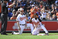 Baltimore Orioles' Cedric Mullins, right, reacts after hitting a triple against the Chicago Cubs in the third inning of a baseball game, Thursday, Aug. 18, 2022, in Baltimore. (AP Photo/Gail Burton)