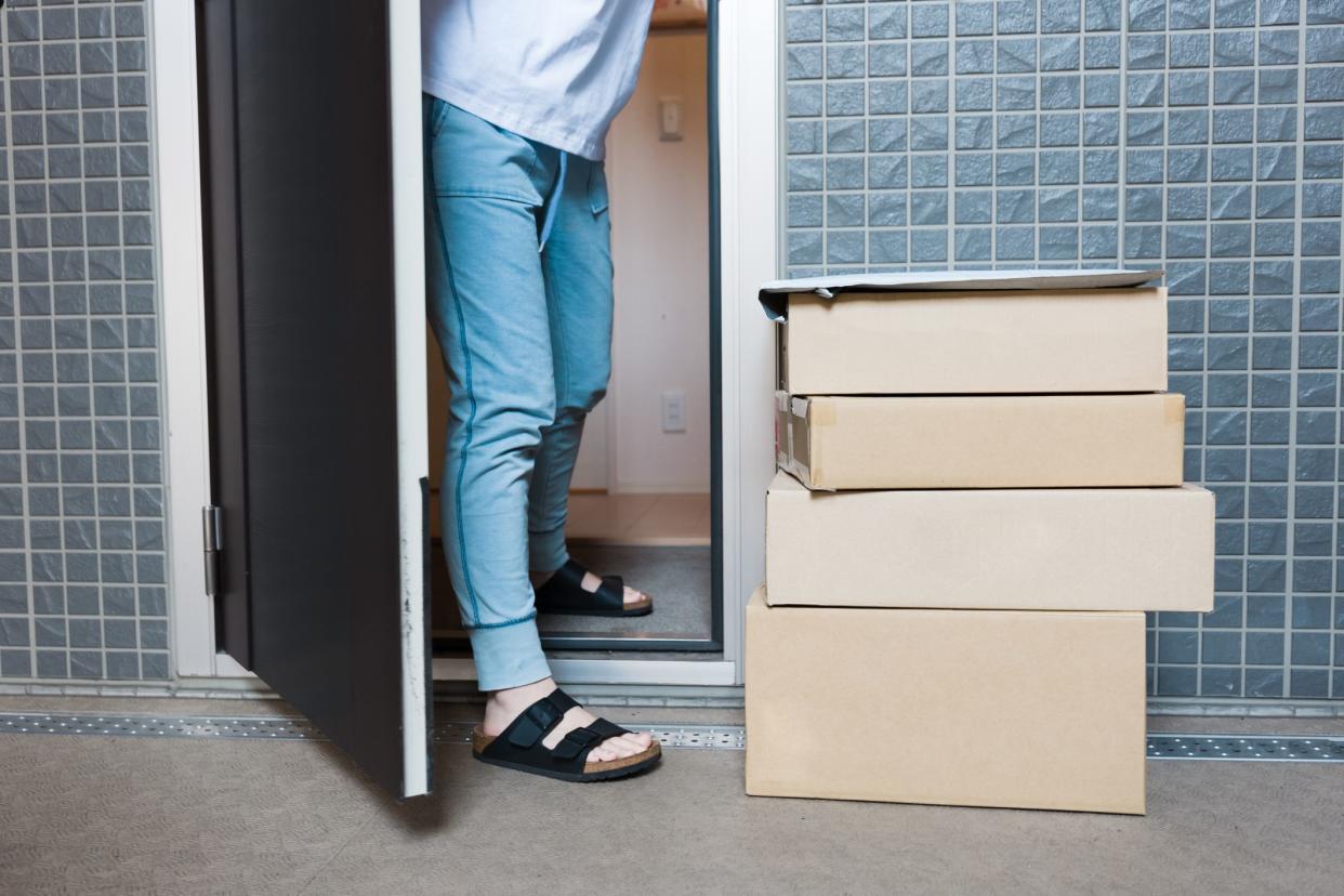 Contactless delivery at the entrance of the apartment, cardboard boxes