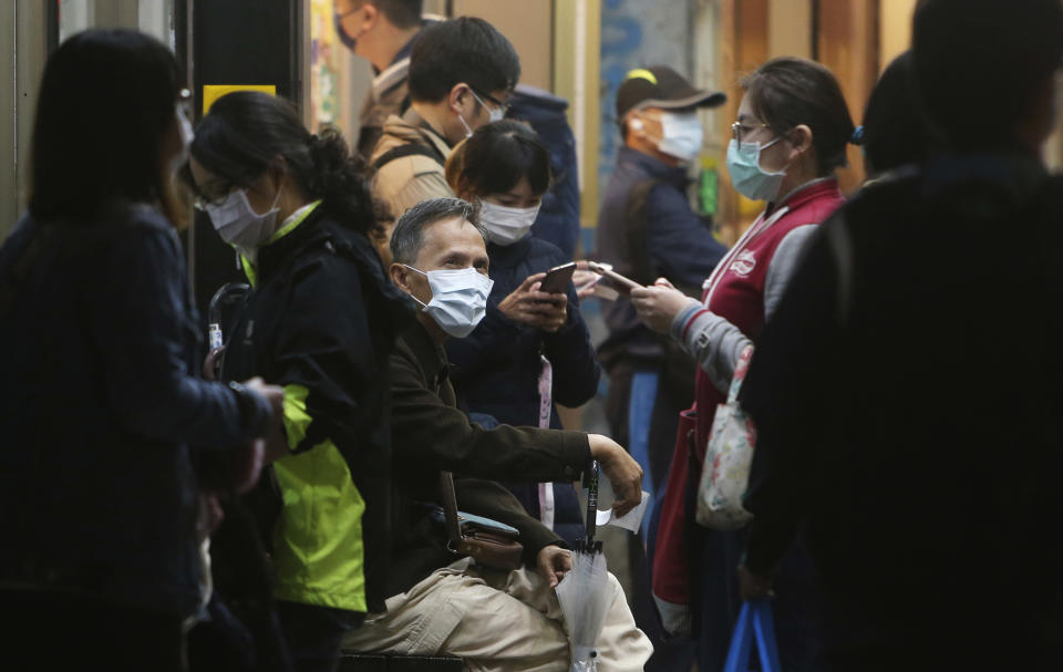 People wear face masks to help curb the spread of the coronavirus in a public area of Taipei, Taiwan, Monday, Nov. 30, 2020. (AP Photo/Chiang Ying-ying)