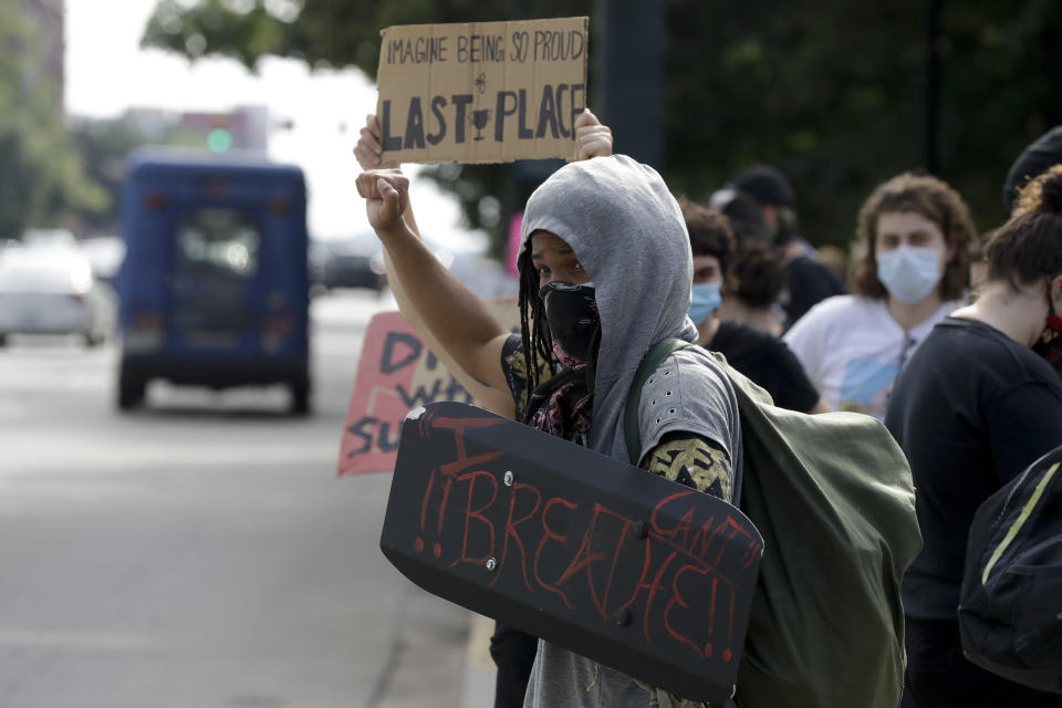 Demonstrators protest in front of a Confederate statue at the State House on Friday, July 10, 2020, in Columbia, S.C. Demonstrators on both sides gathered for the five year anniversary after the Confederate battle flag was removed from the State House grounds after a two-thirds vote by the Legislature. (AP Photo/Chris Carlson)