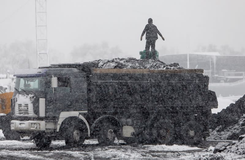 A man stands in a truck loaded with coal amid the energy crunch in Bishkek