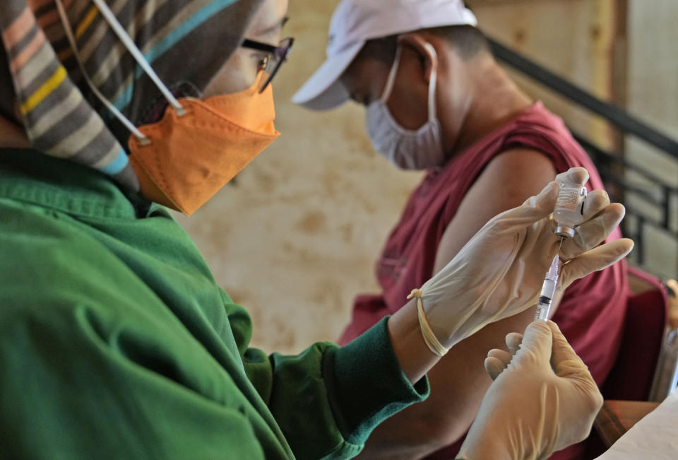 A health worker prepares a shot of the Sinovac COVID-19 vaccine during a mass vaccination in Jakarta, Indonesia, Monday, June 21, 2021. Indonesia's president ordered authorities to speed up the country's vaccination campaign as the World Health Organization warned of the need to increase social restrictions in the country amid a fresh surge of coronavirus infections caused by worrisome variants. (AP Photo/Dita Alangkara)