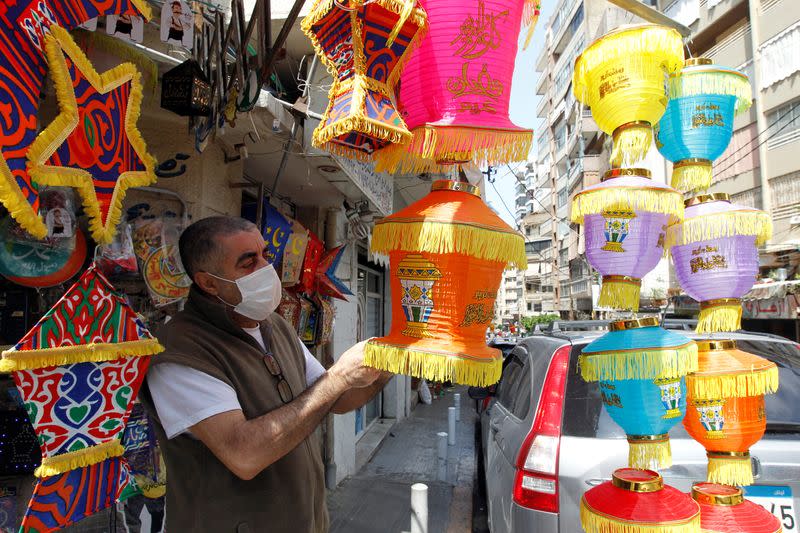 A man checks Ramadan decorations ahead of the Muslim holy month of Ramadan at a shop during a countrywide lockdown over the coronavirus disease (COVID-19) in Beirut