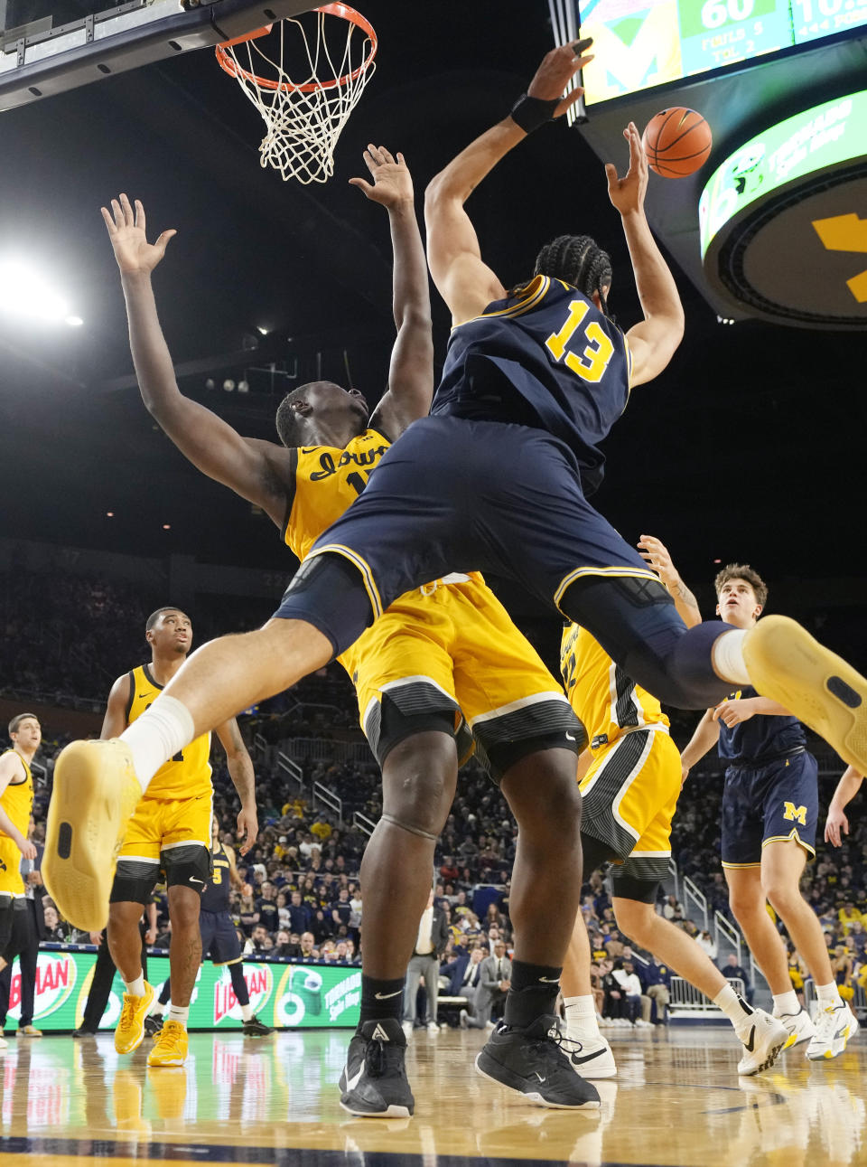 Michigan forward Olivier Nkamhoua (13) and Iowa forward Ladji Dembele (13) reach for the rebound during the second half of an NCAA college basketball game, Saturday, Jan. 27, 2024, in Ann Arbor, Mich. (AP Photo/Carlos Osorio)