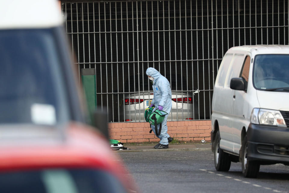 A forensics officer moves medical bags at the scene in Seven Kings, Ilford, east London, where three people died after being stabbed on Sunday (Picture: PA)