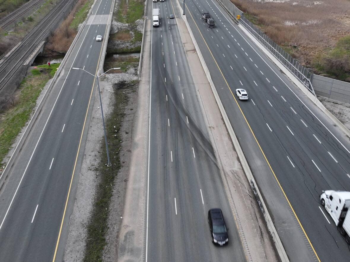 The site of a wrong way crash on Highway 401 on April 29 is shown here. The crash, which involved six vehicles, killed four people. The passenger in the cargo van that caused the crash had been barred from a Vaughan LCBO outlet after he allegedly stole up to $5,000 in merchandise.  (Patrick Morrell/CBC - image credit)
