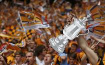 A Hull City supporter holds a cardboard replica of the FA cup before the start of his team's FA Cup final soccer match against Arsenal at Wembley Stadium in London, May 17, 2014. REUTERS/Eddie Keogh (BRITAIN - Tags: SPORT SOCCER)