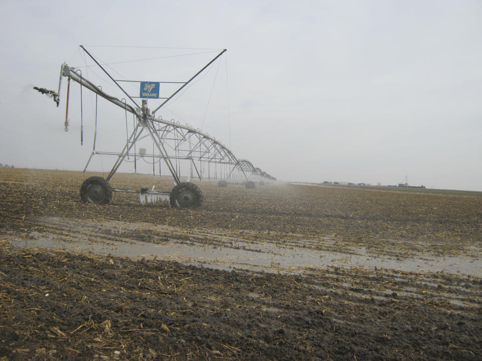 A sprinkler is in use on farmland near Dodge City, Kansas.