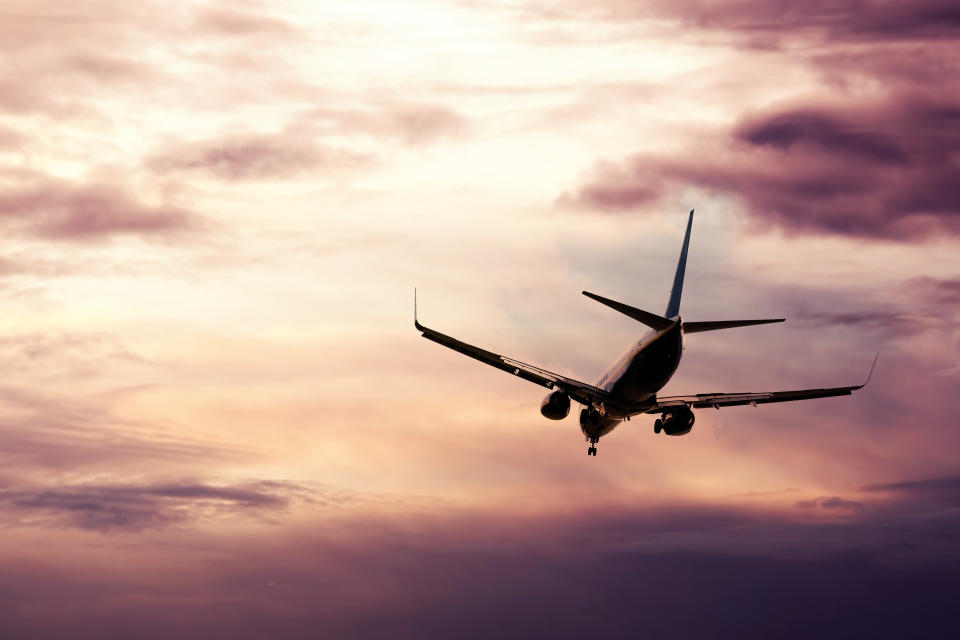 Passenger jet descending in evening sky