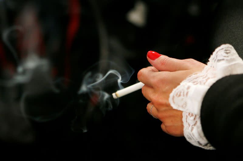 FILE PHOTO: A model smokes backstage before the start of a fall fashion show during New York Fashion Week
