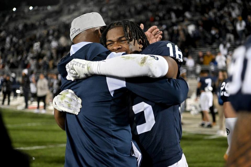 Penn State safety Ji’Ayir Brown gets hugs from coaches after the win over Michigan State on Saturday, Nov. 26, 2022.
