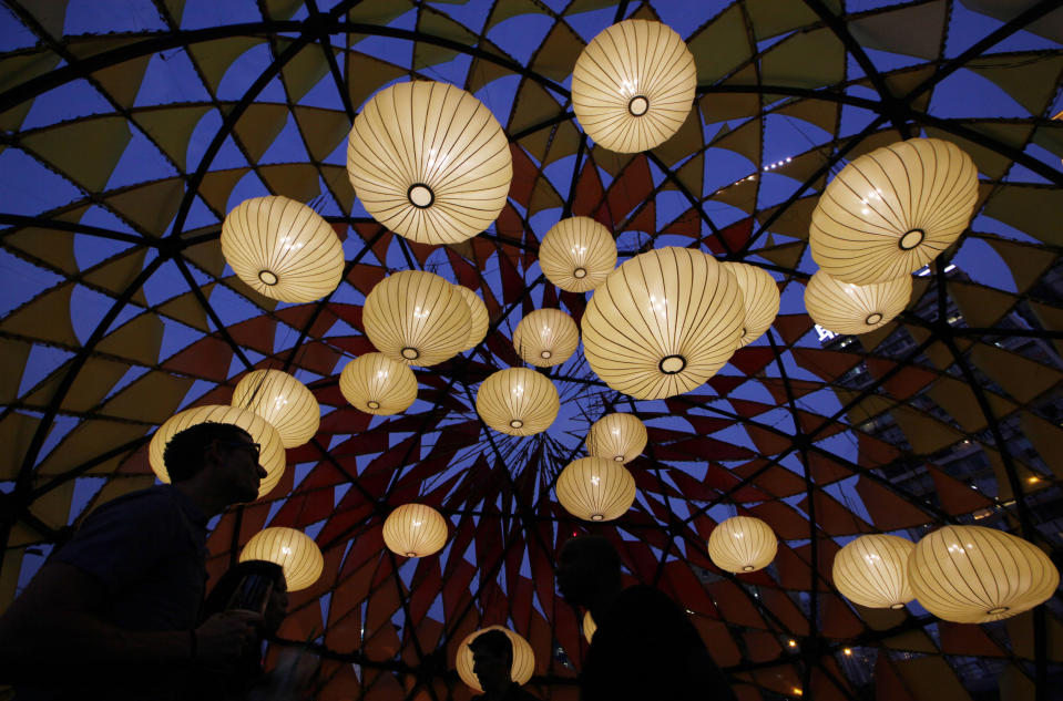 Visitors tour the illuminated decorations and lighting of small bulbs set up at popular Victoria Park to celebrate the Chinese Mid-Autumn Festival in Hong Kong Thursday, Sept. 27, 2012. Like ancient Chinese poets, Hong Kong people appreciate the beauty of the full moon in the Mid-Autumn Festival, which falls on Sunday Sept. 30 this year. Chinese people believe that on that day, the moon will be the biggest, roundest and brightest, and the term "round" implies family reunion in Chinese. (AP Photo/Kin Cheung)