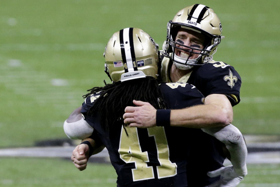 New Orleans Saints quarterback Drew Brees, right, celebrates with running back Alvin Kamara (41) during the second half of an NFL divisional round playoff football game against the Tampa Bay Buccaneers, Sunday, Jan. 17, 2021, in New Orleans. (AP Photo/Butch Dill)