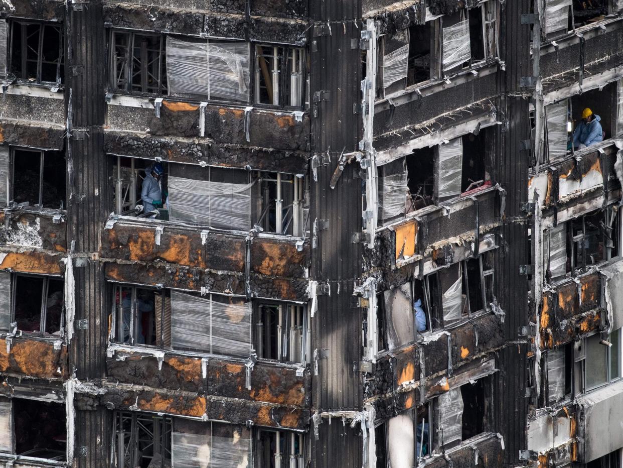 Police investigators are seen inside the burned out shell of Grenfell Tower this week: AFP/Getty Images