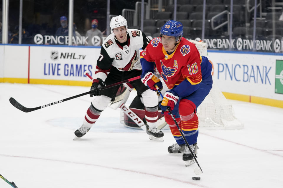 St. Louis Blues' Brayden Schenn (10) looks to pass as Arizona Coyotes' Tyler Pitlick (17) defends during the second period of an NHL hockey game Thursday, Feb. 4, 2021, in St. Louis. (AP Photo/Jeff Roberson)