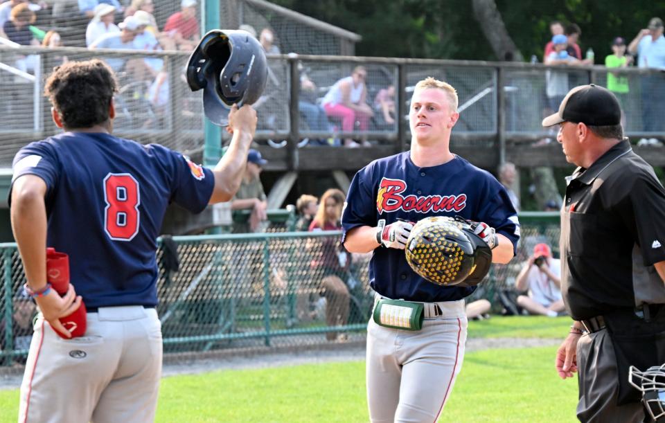Sam Petersen (right) crosses the plate celebrating with Bourne teammate Kendall Diggs after hitting a two-run homer against Cotuit in the second inning of a game on Monday in Cotuit.