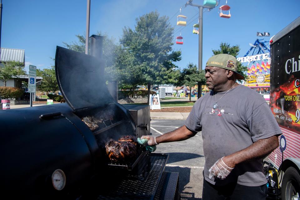 James McDuffie, co-owner of Mema’s Chick’n’ & Ribs, smokes meats at the NC Mountain State Fair, September 11, 2023.