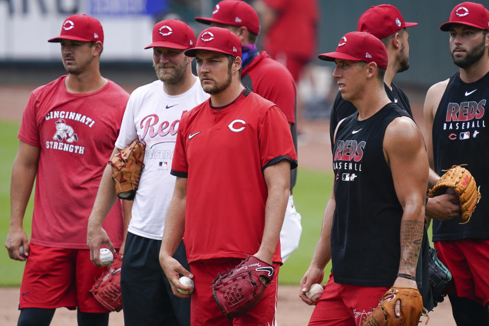 Cincinnati Reds pitcher Trevor Bauer (center) stands with other members of the pitching staff during team baseball practice at Great American Ballpark in Cincinnati, Wednesday, July 8, 2020. (AP Photo/Bryan Woolston)