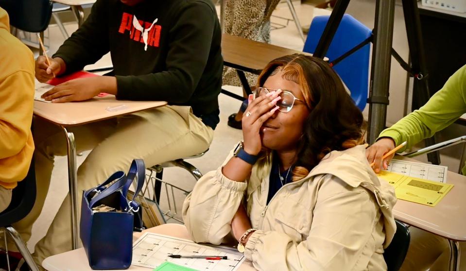 Canton High School student Ahniya Myers reacts to a video from noted author Angie Thomas. Myers learned from Thomas that she was receiving a full scholarship to attend Jackson's Belhaven University, Thomas' alma mater.