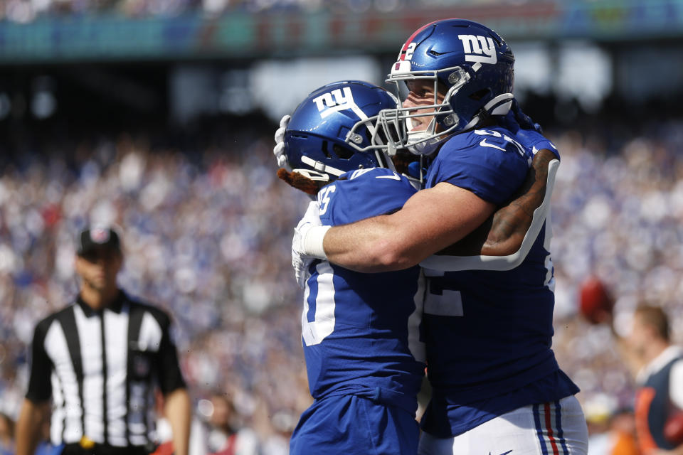 New York Giants' Daniel Bellinger, right, celebrates his touchdown with Richie James during the second half an NFL football game against the Carolina Panthers, Sunday, Sept. 18, 2022, in East Rutherford, N.J. (AP Photo/John Munson)
