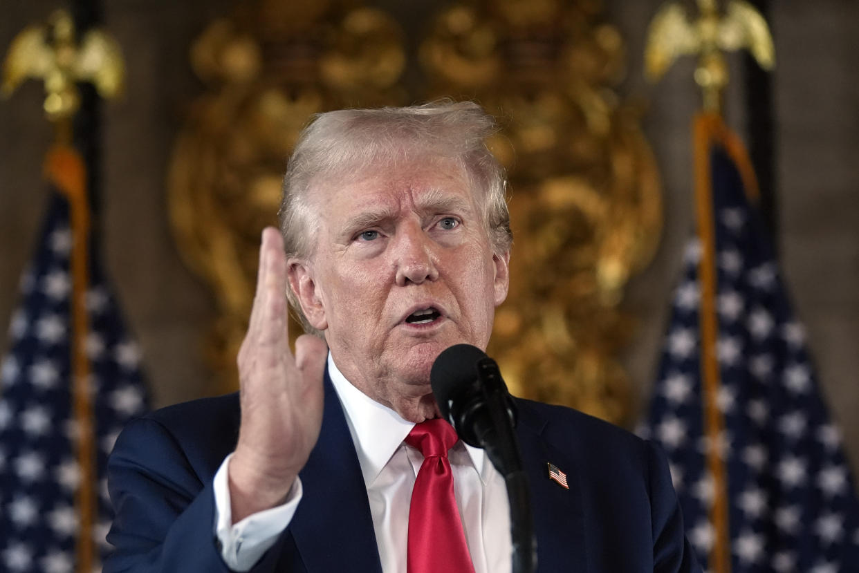 Former President Donald Trump speaks and gestures with his right hand to reporters during a news conference at his Mar-a-Lago estate in Palm Beach, Fla., on Aug. 8.