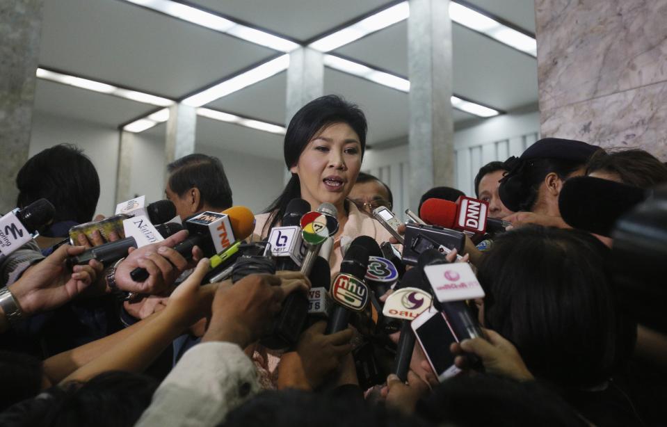 Thai Prime Minister Yingluck Shinawatra speaks to reporters following following the declaration of a state of emergency in Bangkok