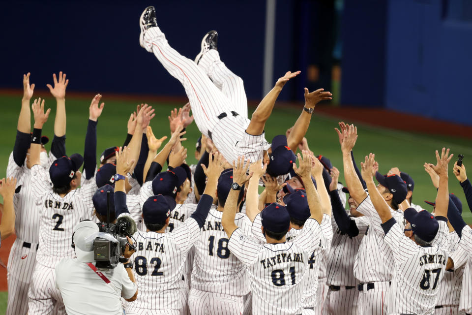 YOKOHAMA, JAPAN - AUGUST 07: Head coach Atsunori Inaba #80 of Team Japan is tossed into the air as they celebrate winning the gold after their 2-0 victory over Team United States in the gold medal game between Team United States and Team Japan on day fifteen of the Tokyo 2020 Olympic Games at Yokohama Baseball Stadium on August 07, 2021 in Yokohama, Kanagawa, Japan. (Photo by Koji Watanabe/Getty Images)