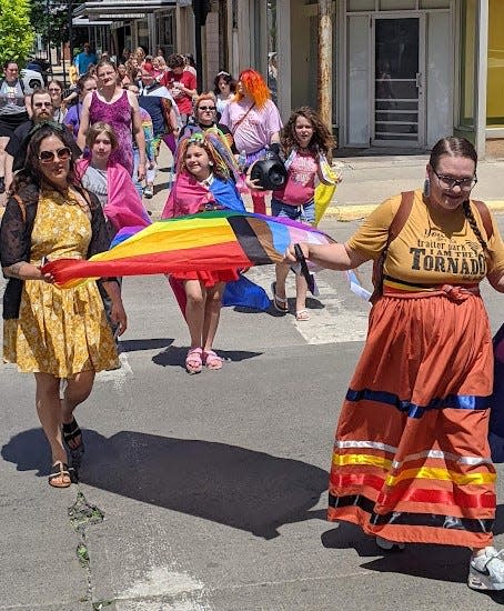 Walkers in a solidary march approach the Red Rooster Coffee House Saturday afternoon during the Aberdeen Area Pride Festival.