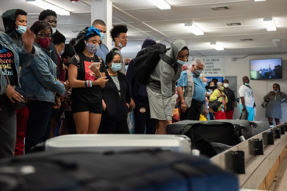 Passengers arriving from Atlanta wait for their luggage inside a crowded baggage claim building at Trenton-Mercer Airport on Monday, July 26, 2021. [MICHELE HADDON / PHOTOJOURNALIST]