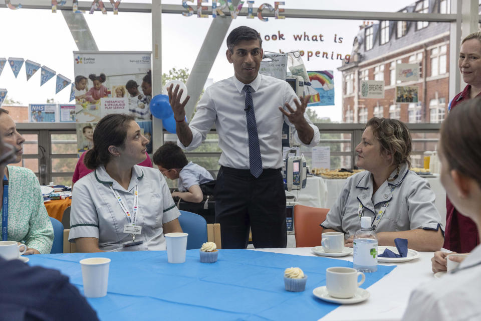 Prime Minister Rishi Sunak visits the Evelina Children's ward at St Thomas' hospital to take part in a NHS Big Tea celebration to mark the 75th anniversary of the NHS, in central London, Tuesday July 4, 2023.. (Jack Hill/Pool Photo via AP)