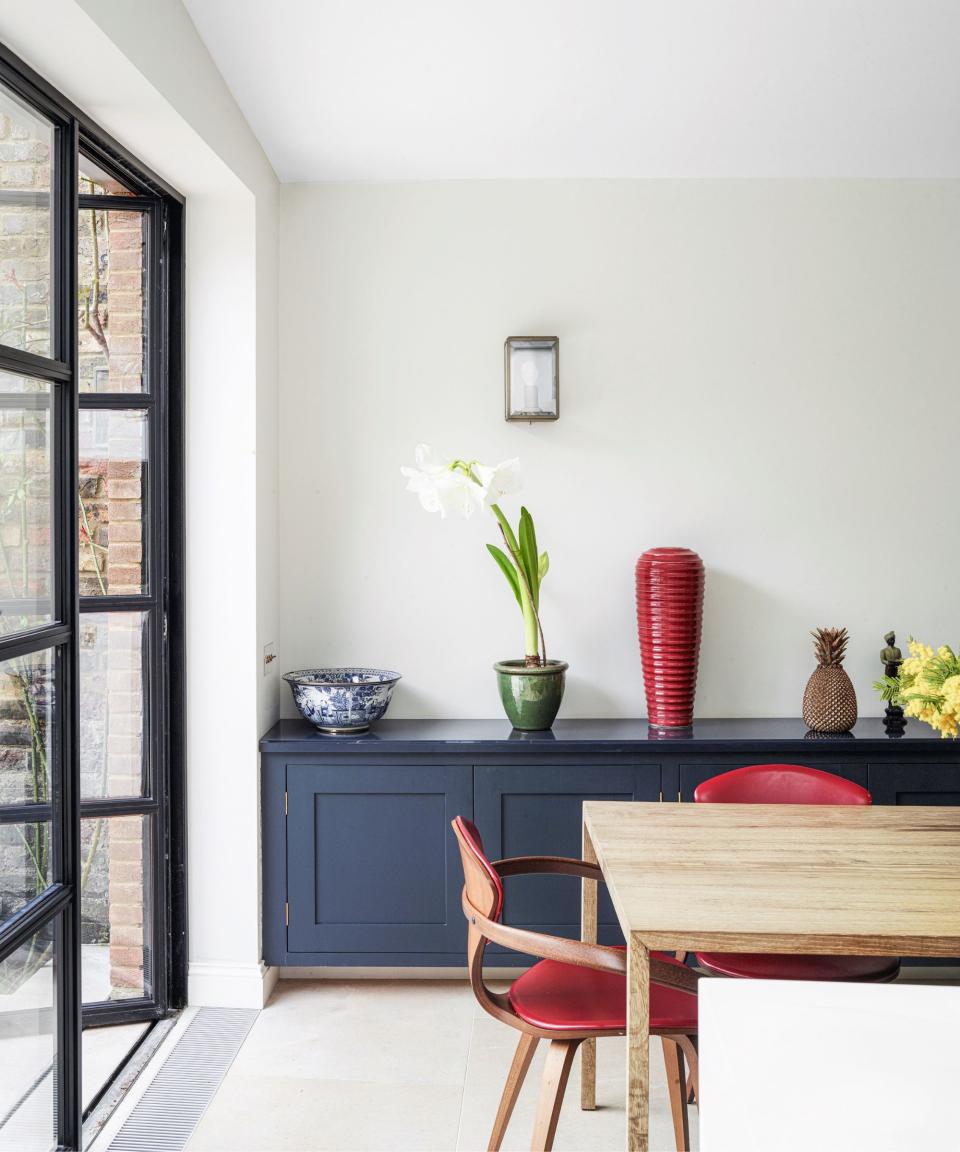 Red chairs and vase, blue cabinet