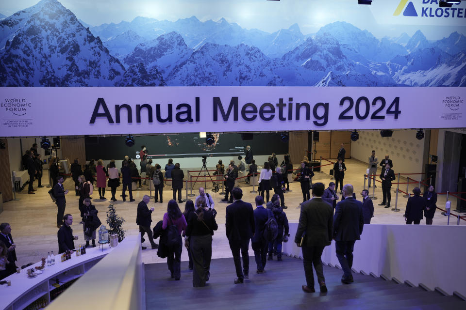 Participants walk through congress centre of the Annual Meeting of World Economic Forum in Davos, Switzerland, Wednesday, Jan. 17, 2024. The annual meeting of the World Economic Forum is taking place in Davos from Jan. 15 until Jan. 19, 2024.(AP Photo/Markus Schreiber)