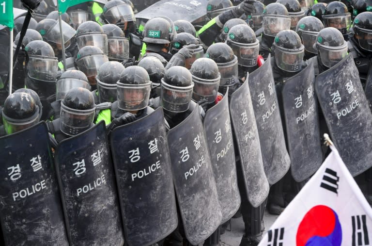 South Korean supporters of president Park Geun-Hye clash with police in Seoul after the announcement of her impeachment