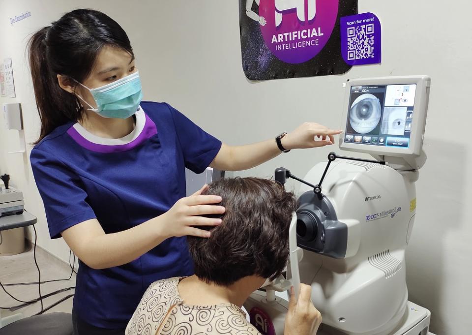 An optometrist checks a patient's retina and optic nerve using the OCT machine. ― Picture courtesy of VISTA Eye Specialist