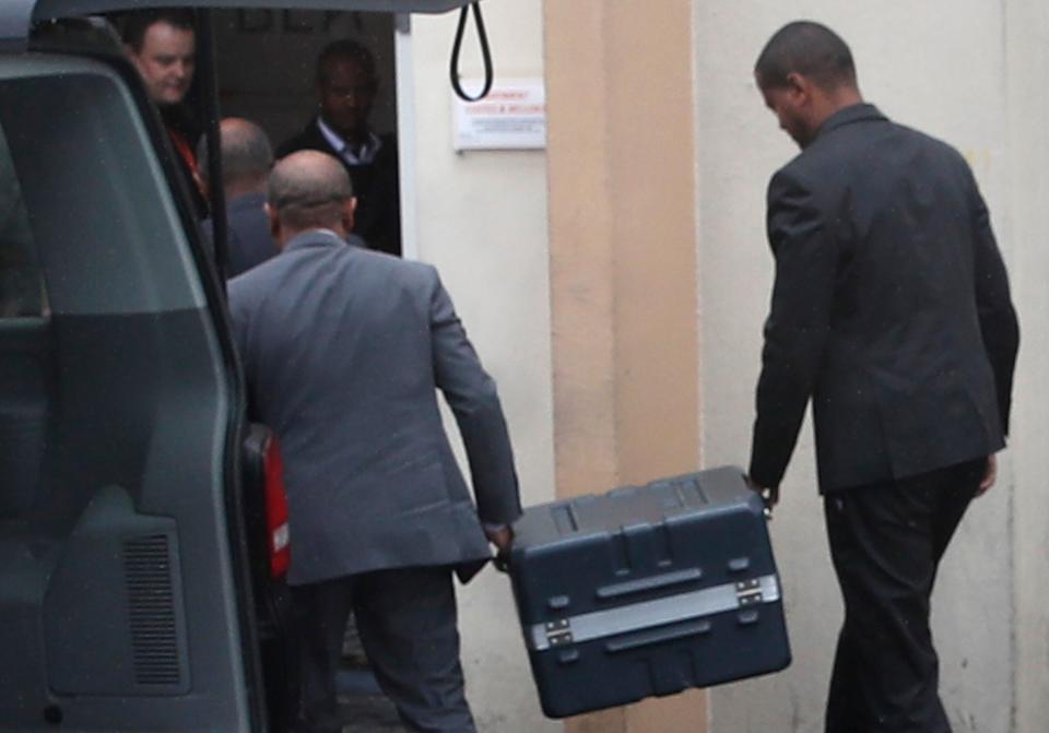 Two men carry suitcases containing the flight recorders from the Ethiopian jet, into the French air accident investigation authority, Thursday, March 14, 2019 in Le Bourget, north of Paris.