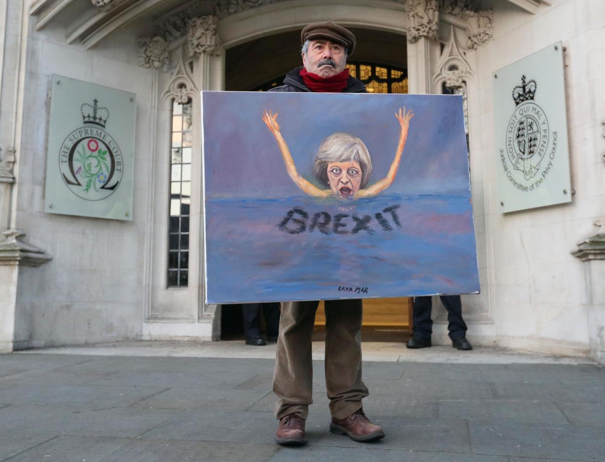 Satirical artist Kaya Mar poses with a Brexit-themed artwork depicting British Prime Minister Theresa May, as he stands outside the Supreme Court in London in January: AFP/Getty