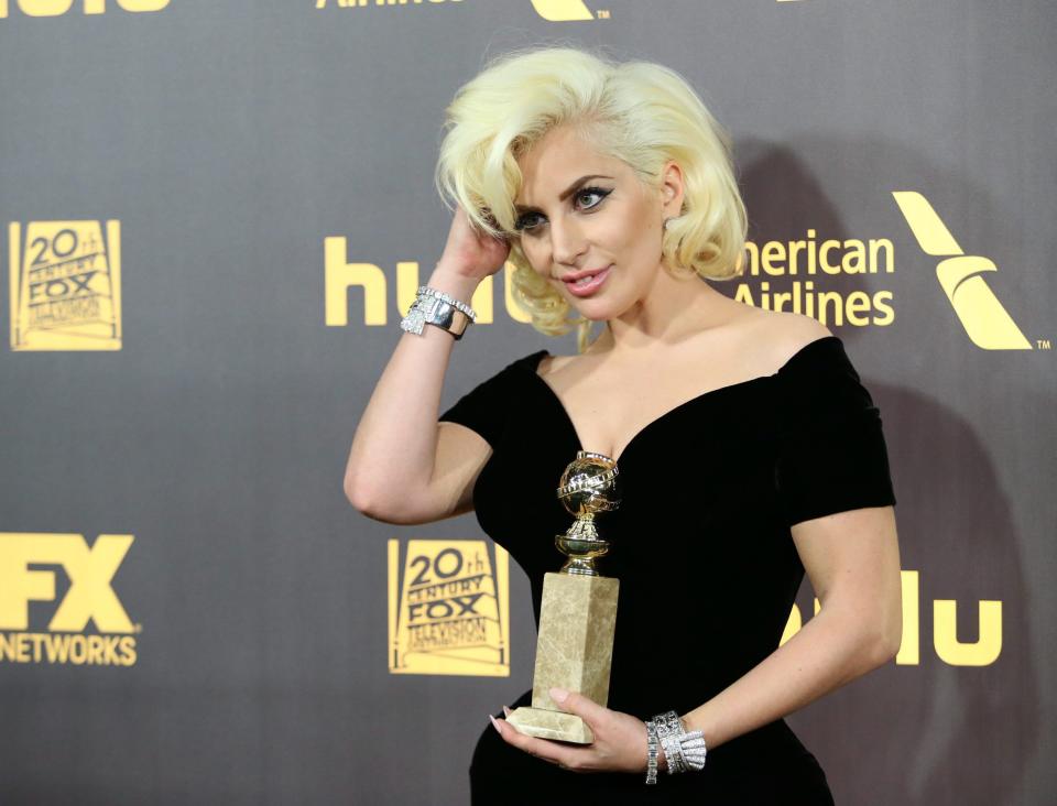 Lady Gaga poses with her award for best performance by an actress in a limited series or a motion picture made for television for 