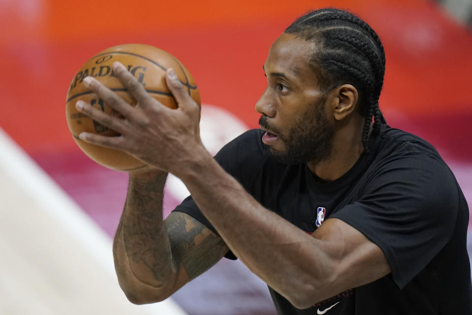 Kawhi Leonard warms up before a game this season.