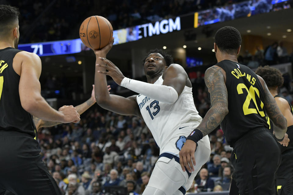 Memphis Grizzlies forward Jaren Jackson Jr. (13) shoots against Utah Jazz forward John Collins (20) in the second half of an NBA basketball game Wednesday, Nov. 29, 2023, in Memphis, Tenn. (AP Photo/Brandon Dill)