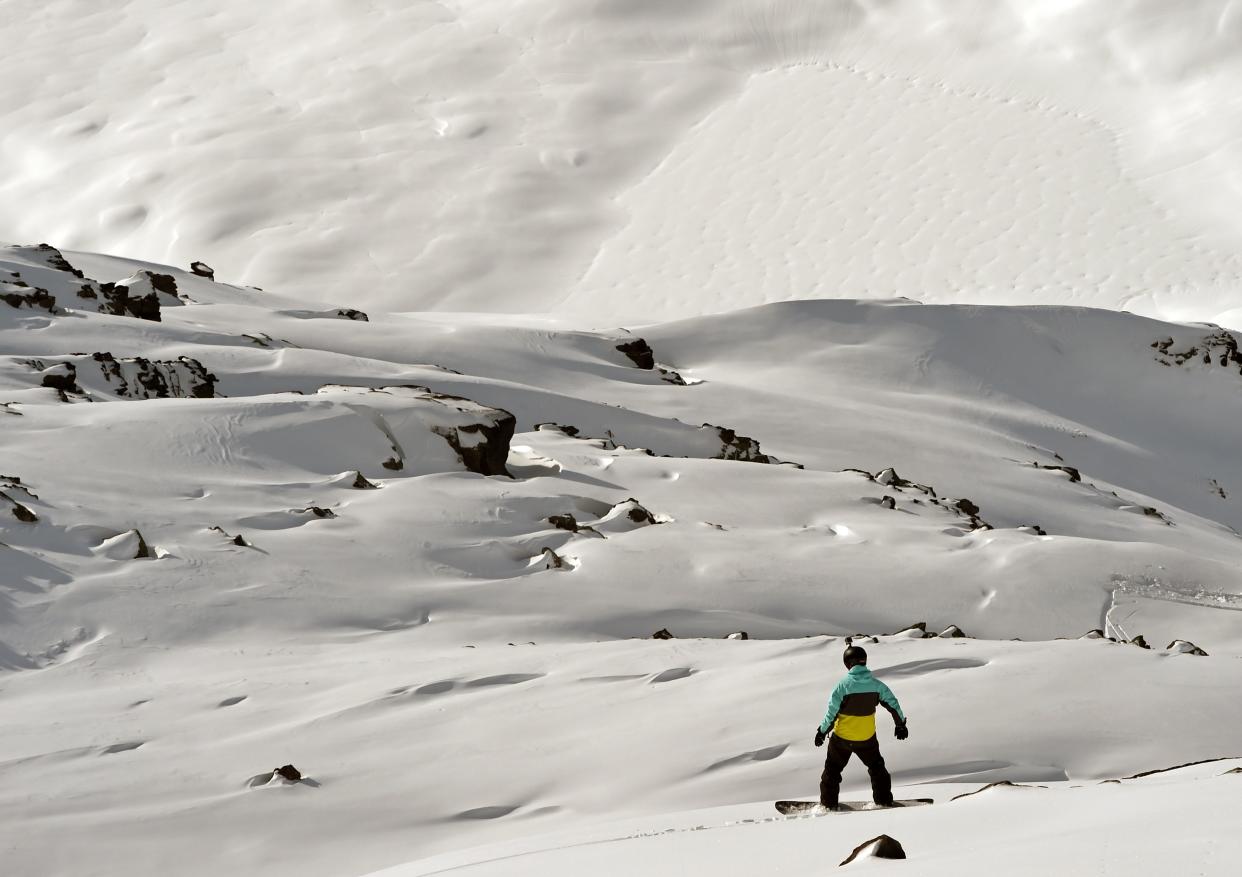 A man surfs off of marked ski slopes despite of an avalanch risk, on February 2, 2016 in the French ski resort of Meribel in the 3 Valleys ski area, the world's largest ski area, in central French Alps. 
French ski resorts prepare for the French winter school holidays' rush that will start on February 6. / AFP / PHILIPPE DESMAZES        (Photo credit should read PHILIPPE DESMAZES/AFP via Getty Images)