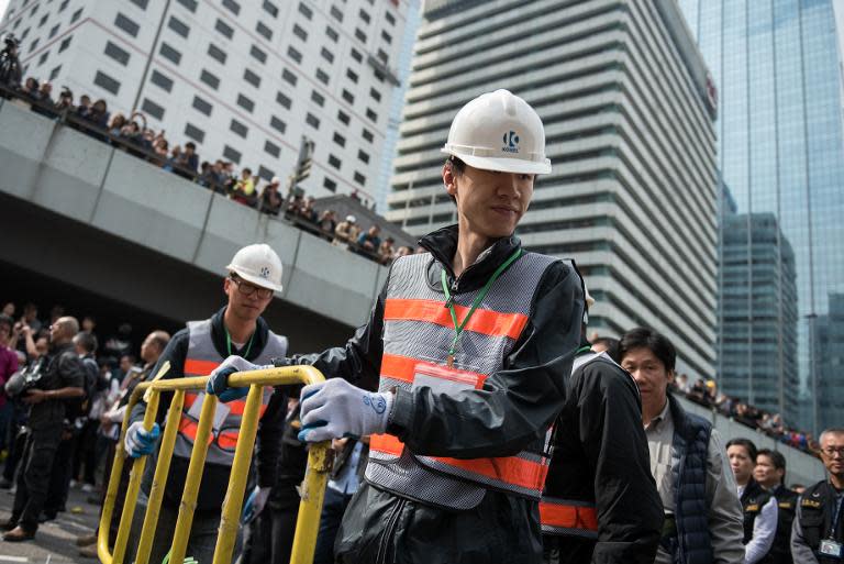 Authorities dismantle a barricade set up by pro-democracy protesters in Hong Kong, on December 11, 2014