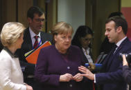 French President Emmanuel Macron, right, speaks with German Chancellor Angela Merkel, center, and European Commission President Ursula von der Leyen, left, during a round table meeting at an EU summit in Brussels, Thursday, Feb. 20, 2020. After almost two years of sparring, the EU will be discussing the bloc's budget to work out Europe's spending plans for the next seven years. (AP Photo/Olivier Matthys)