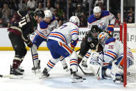 Edmonton Oilers goaltender Jack Campbell (36) makes a save in front of Oilers defenseman Brett Kulak (27), center Nick Bjugstad (72) and defenseman Vincent Desharnais (73) on a shot by Arizona Coyotes center Nathan Smith (13) and right wing Brett Ritchie (24) in the second period during an NHL hockey game, Monday, March 27, 2023, in Tempe, Ariz. (AP Photo/Rick Scuteri)