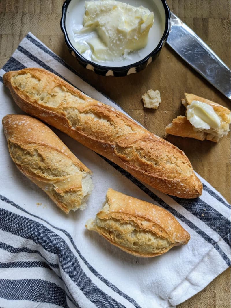 Trader Joe's french baguette with ramekin of butter beside.