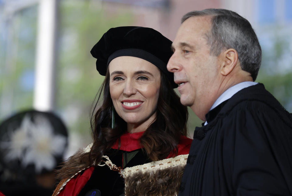 New Zealand Prime Minister Jacinda Ardern speaks with Harvard President Larry Bacow on the stage during Harvard's 371st Commencement, Thursday, May 26, 2022, in Cambridge, Mass. Ardern was the keynote speaker and received an honorary degree. (AP Photo/Mary Schwalm)