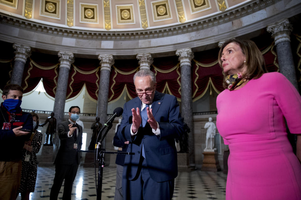 Senate Minority Leader Sen. Chuck Schumer of N.Y., left, accompanied by House Speaker Nancy Pelosi of Calif., right, speak to members of the media after meeting with Treasury Secretary Steven Mnuchin and White House Chief of Staff Mark Meadows as they continue to negotiate a coronavirus relief package on Capitol Hill in Washington, Friday, Aug. 7, 2020. (AP Photo/Andrew Harnik)