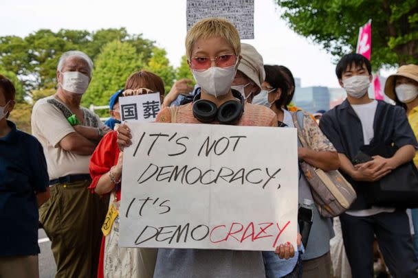 PHOTO: Demonstrators hold signs in protest of the state funeral being held, Sept. 27, 2022, in Japan for former Prime Minister, Shinzo Abe, in Tokyo. (Anthony Trotter/ABC News)