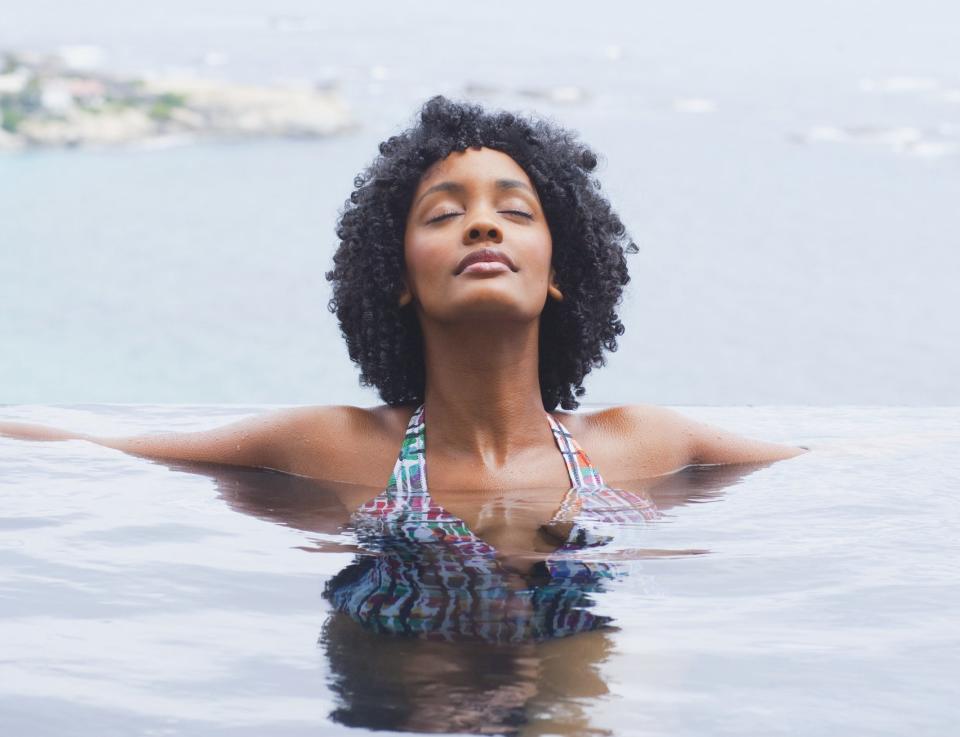 A woman in water with her eyes closed