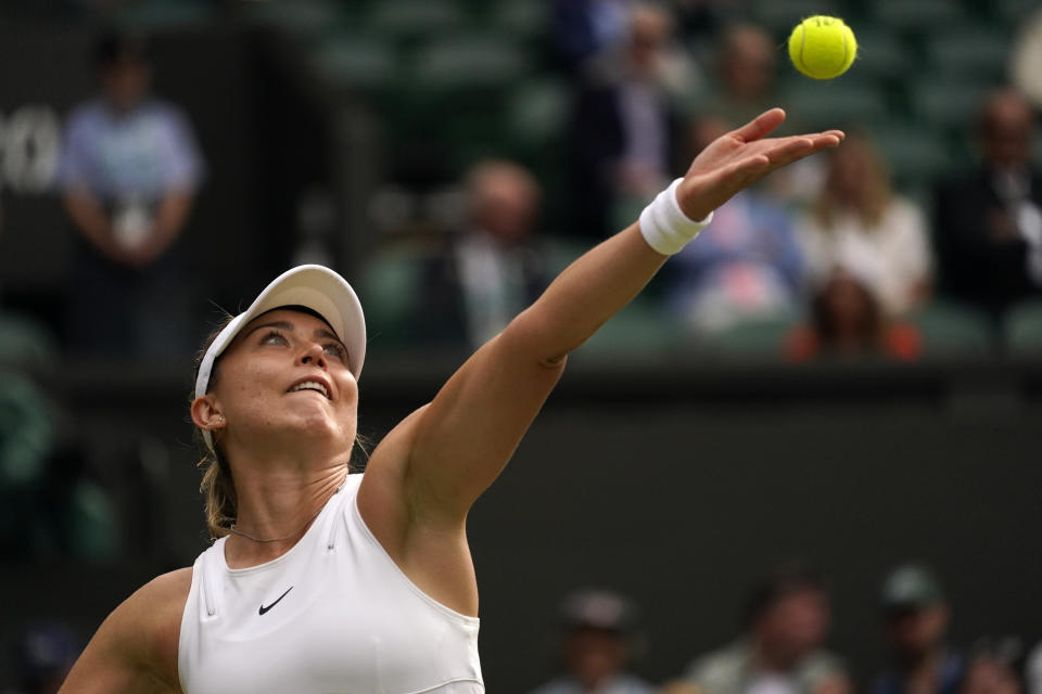 Spain's Paula Badosa serves to Romania's Simona Halep in a women's singles fourth round match on day eight of the Wimbledon tennis championships in London, Monday, July 4, 2022. (AP Photo/Alberto Pezzali)